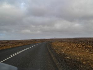 Road across lava fields Reykjanes Iceland